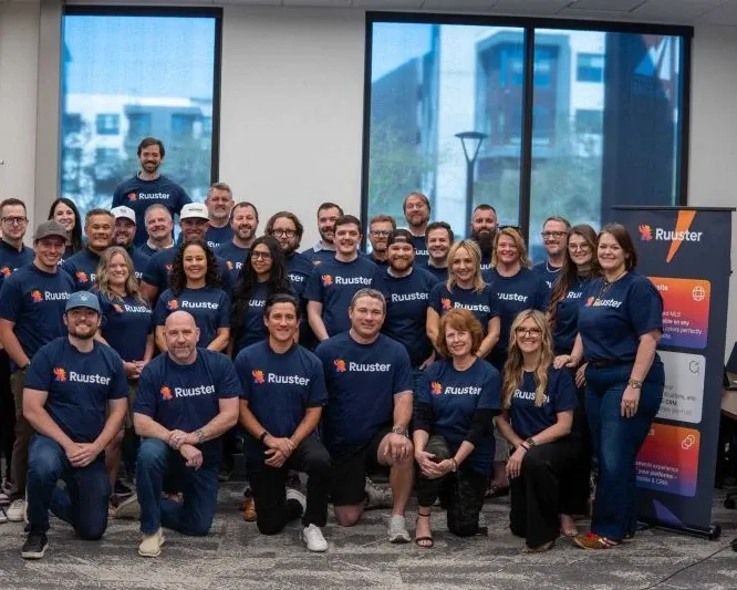 Ruuster branded t-shirts worn by a large group at Leaders of the Flock Mastermind, Scottsdale 2026. AI real estate platform by WeGrow.