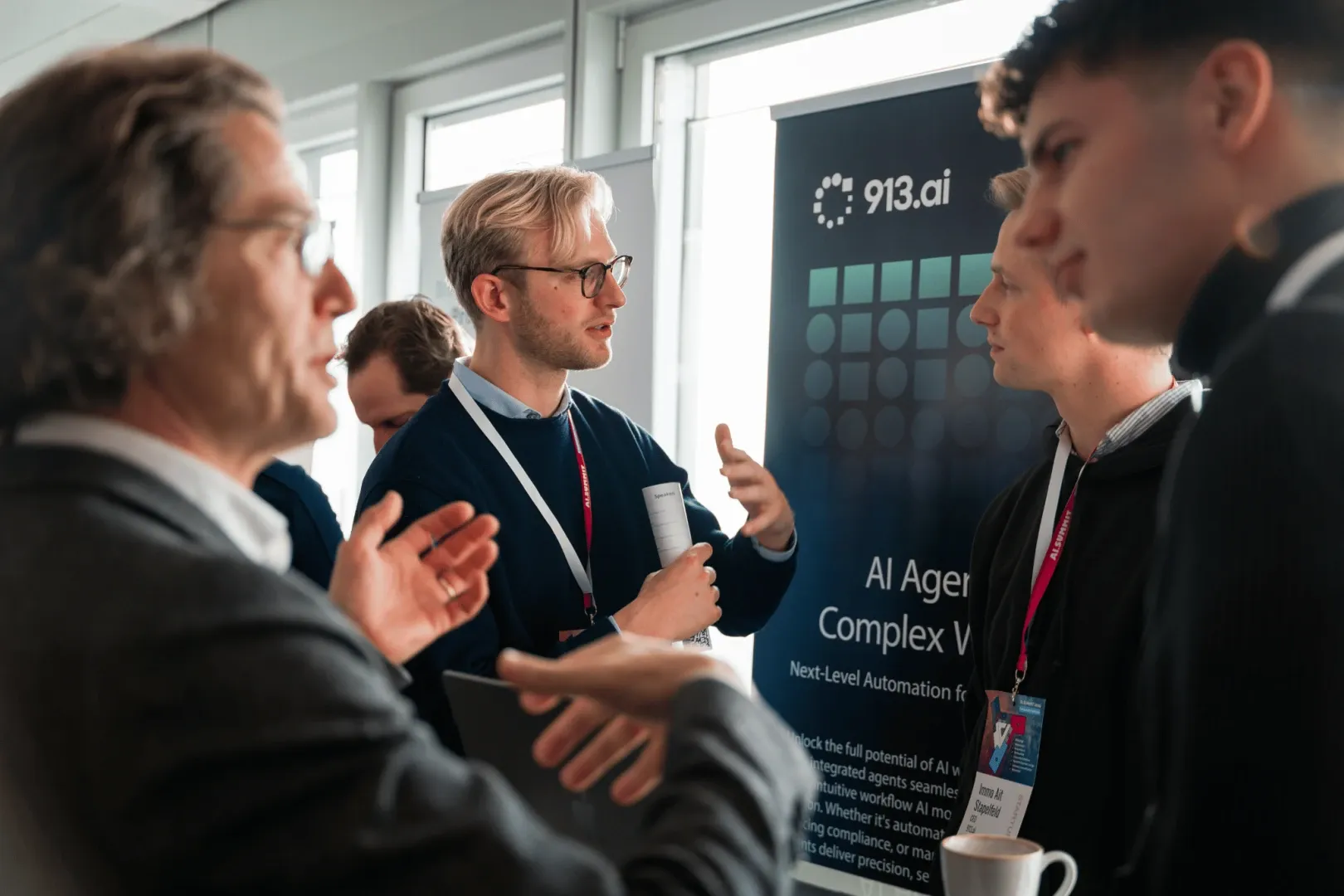 913.ai brand identity on roll-up banner at AI Summit Hamburg 2025. AI agents platform identity by WeGrow.